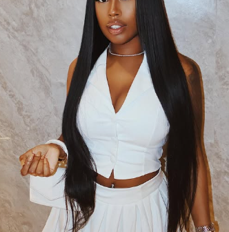 Songstress Cocotrey Stuns in Elegant White Ensemble with a Powerful Caption